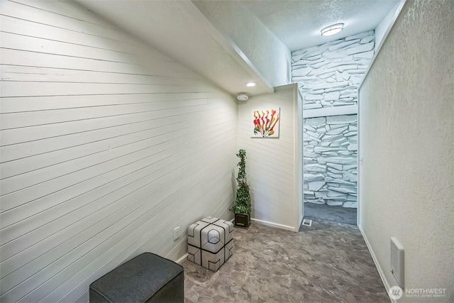 10231 Kiwa Dr SE, Olympia, WA 98513 - corridor featuring wooden walls, visible vents, a textured ceiling, and a textured wall
