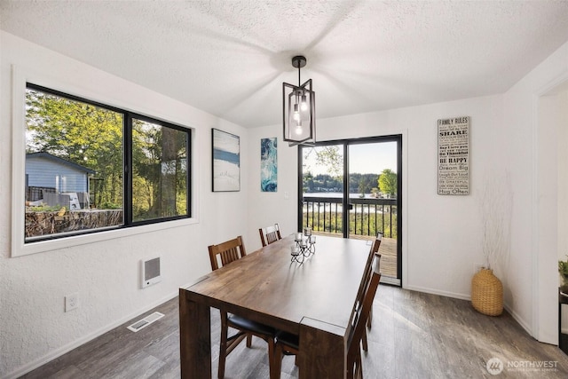 10231 Kiwa Dr SE, Olympia, WA 98513 - dining room featuring baseboards, visible vents, a textured ceiling, and wood finished floors