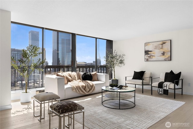 living room with a healthy amount of sunlight, a view of city, and wood finished floors