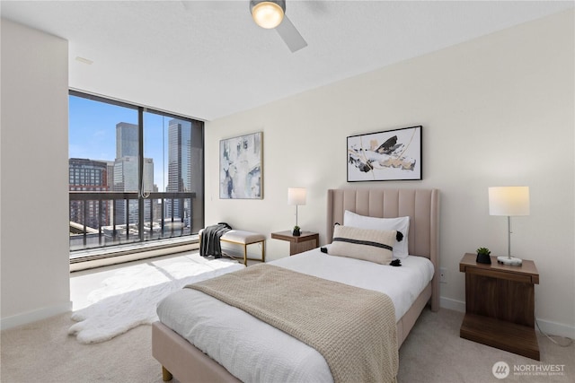 bedroom with a city view, baseboards, and carpet flooring