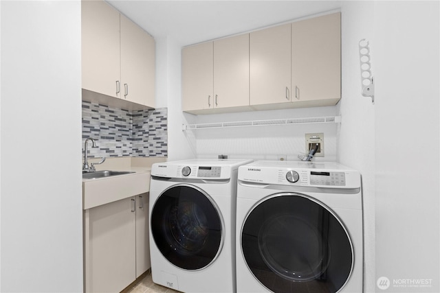 laundry room with a sink, cabinet space, and separate washer and dryer