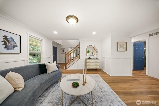 30427AVE SE 204th, Kent, WA 98042 - living area with stairs, crown molding, wood finished floors, a decorative wall, and wainscoting
