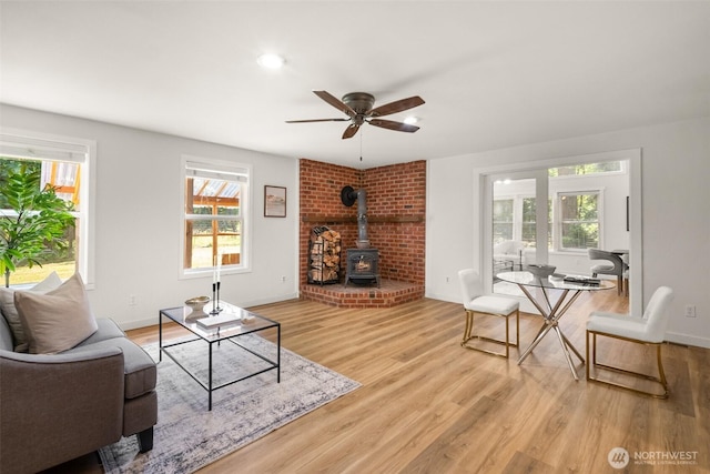 30427AVE SE 204th, Kent, WA 98042 - living room with a wood stove, plenty of natural light, wood finished floors, ceiling fan, and recessed lighting