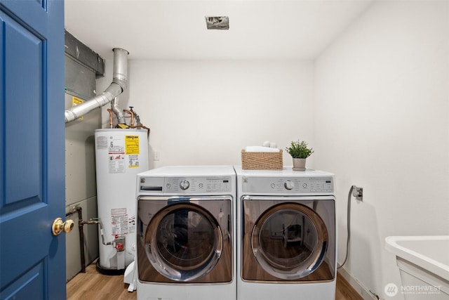 30427AVE SE 204th, Kent, WA 98042 - washroom with gas water heater, washer and dryer, and wood finished floors
