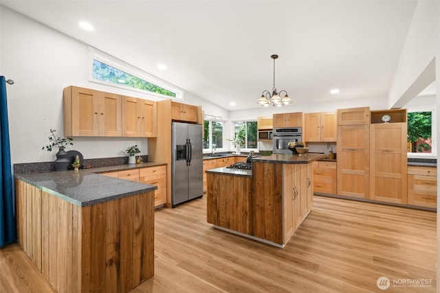 30427AVE SE 204th, Kent, WA 98042 - kitchen with stainless steel appliances, vaulted ceiling, light wood-style floors, a peninsula, and a chandelier