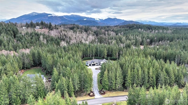 drone / aerial view featuring a mountain view and a wooded view