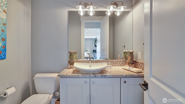 bathroom featuring toilet and vanity