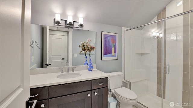 bathroom featuring vanity, a shower stall, toilet, and lofted ceiling