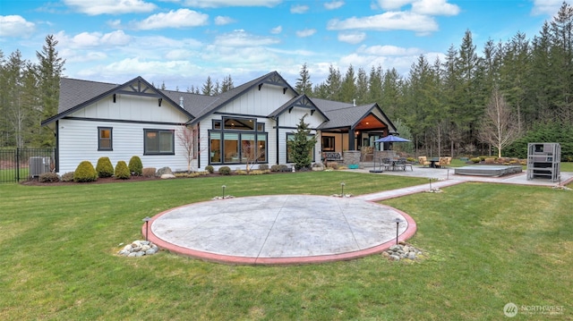 back of house featuring a yard, central AC unit, board and batten siding, and a patio area