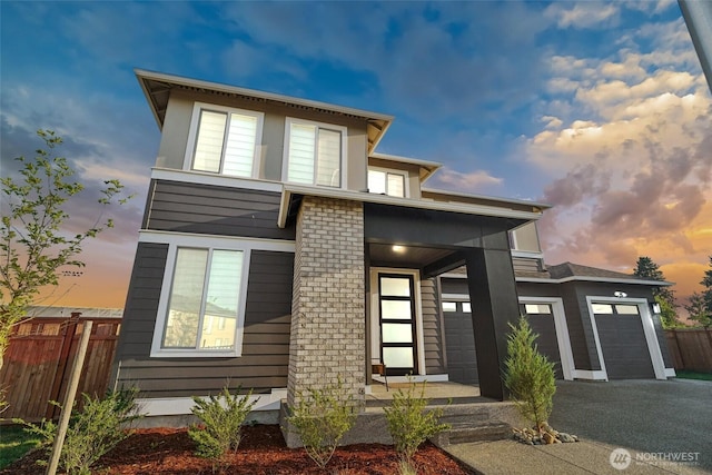 12673 SE 287th Ct, Auburn, WA 98092 - modern home with fence, driveway, an attached garage, and covered porch
