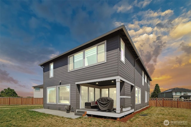 12673 SE 287th Ct, Auburn, WA 98092 - back of house at dusk with a patio and a deck