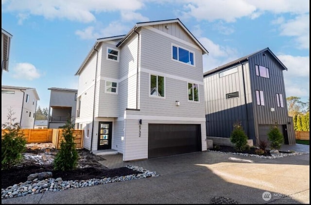 6732 21st Ave SW, Seattle, WA 98106 - view of front facade with a garage, board and batten siding, and driveway