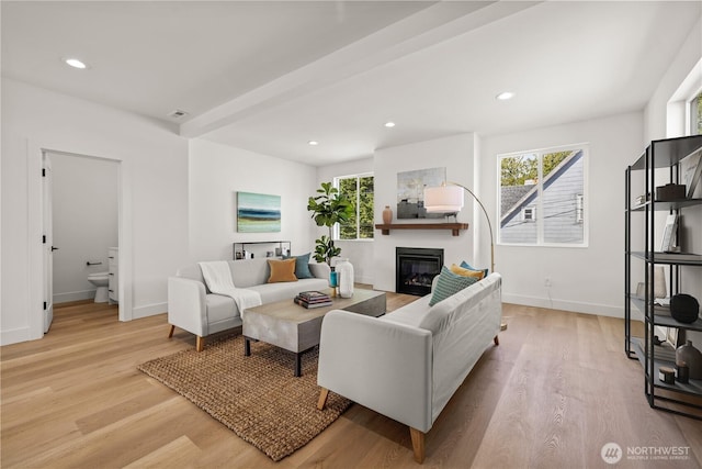 6732 21st Ave SW, Seattle, WA 98106 - living room with light wood-type flooring, a glass covered fireplace, baseboards, and recessed lighting