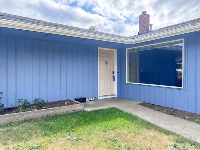 475 SE Pasek St, Oak Harbor, WA 98277 - view of exterior entry with a chimney and roof with shingles