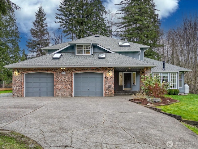 view of front of property with a front yard, concrete driveway, a garage, and roof with shingles