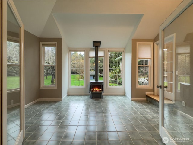unfurnished sunroom with french doors and a wood stove