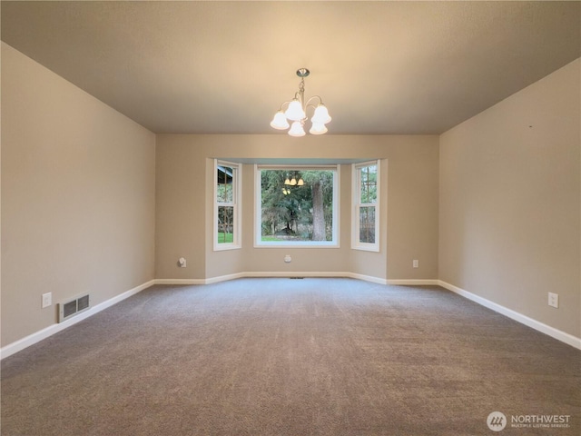 spare room with baseboards, carpet floors, visible vents, and an inviting chandelier