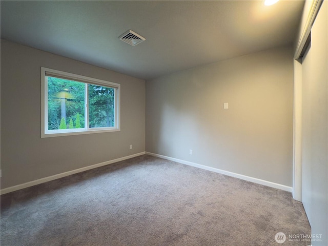unfurnished room featuring carpet floors, baseboards, and visible vents