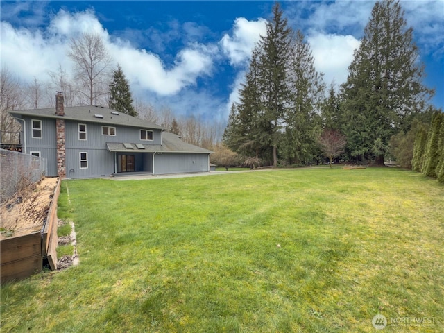 view of yard with fence and a patio