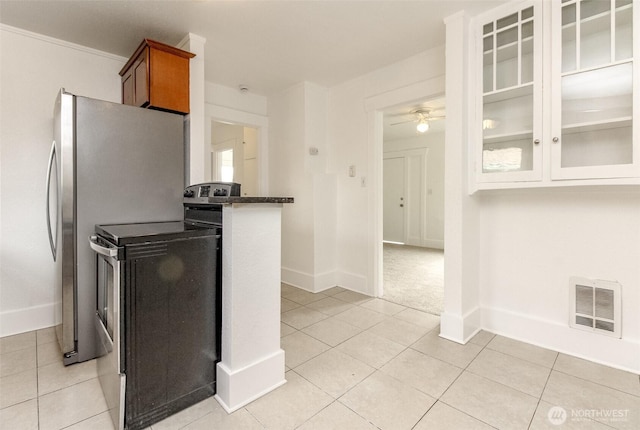 515 S 37th, Tacoma, WA 98418 - kitchen with light tile patterned flooring, glass insert cabinets, visible vents, and baseboards