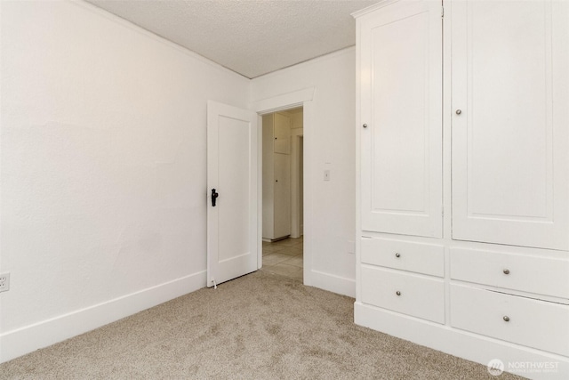 515 S 37th, Tacoma, WA 98418 - unfurnished bedroom featuring baseboards, light colored carpet, and a textured ceiling