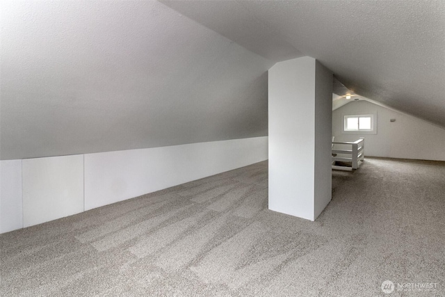 515 S 37th, Tacoma, WA 98418 - additional living space with carpet floors, vaulted ceiling, and a textured ceiling