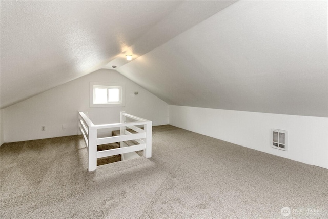 515 S 37th, Tacoma, WA 98418 - additional living space with visible vents, lofted ceiling, carpet, and a textured ceiling