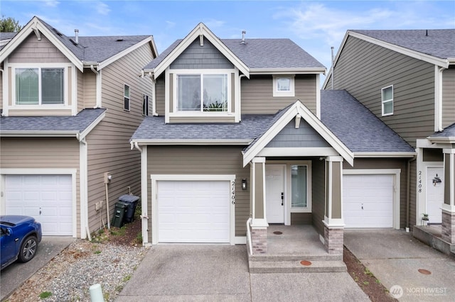 view of front facade featuring an attached garage, a shingled roof, and concrete driveway