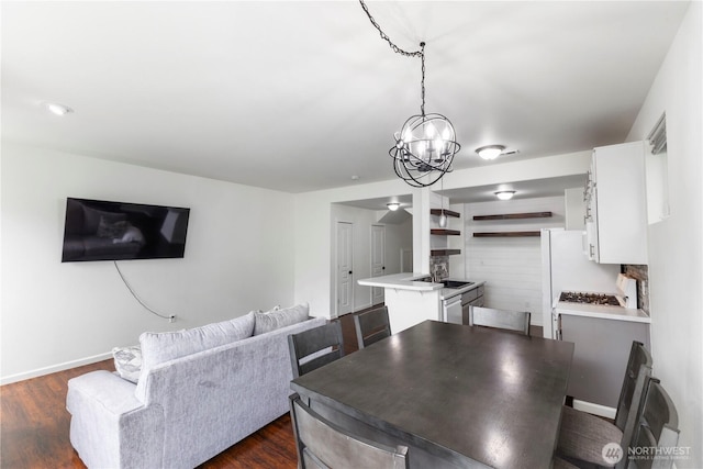 dining space with baseboards, an inviting chandelier, and dark wood-type flooring