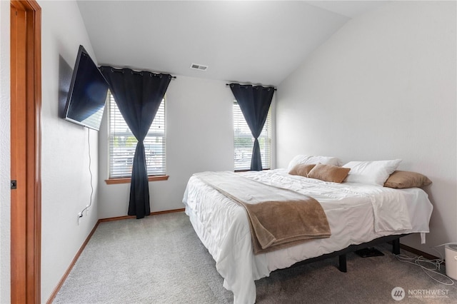 carpeted bedroom featuring baseboards, lofted ceiling, and visible vents