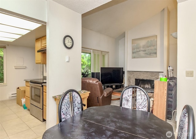 17514 151st Ave SE Unit 1-16, Renton, WA 98058 - dining space featuring a baseboard heating unit, vaulted ceiling, light tile patterned flooring, and a fireplace