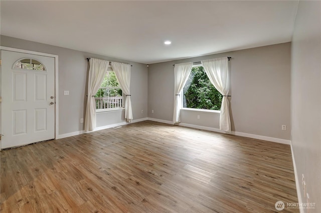 entryway with recessed lighting, baseboards, and light wood-type flooring