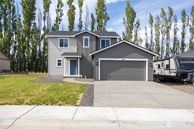425 Pear Dr, Tieton, WA 98947 - traditional-style home featuring a front yard, board and batten siding, concrete driveway, and an attached garage