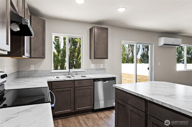 425 Pear Dr, Tieton, WA 98947 - kitchen with stainless steel appliances, under cabinet range hood, a sink, dark brown cabinetry, and a wall mounted air conditioner