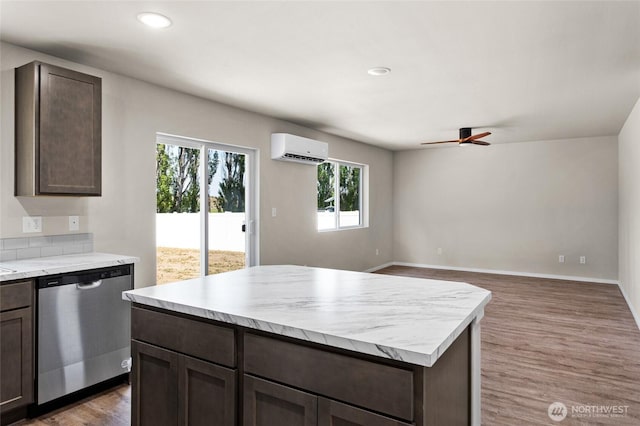 425 Pear Dr, Tieton, WA 98947 - kitchen with a wall mounted air conditioner, dark brown cabinets, and stainless steel dishwasher