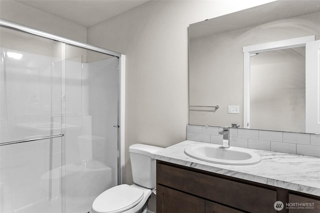 425 Pear Dr, Tieton, WA 98947 - full bathroom featuring toilet, vanity, tasteful backsplash, and a shower stall