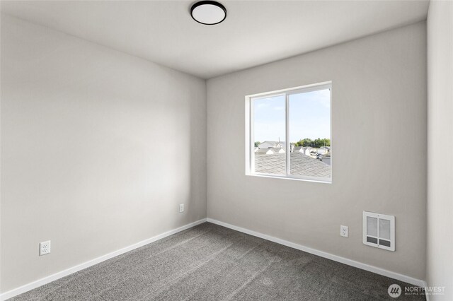 425 Pear Dr, Tieton, WA 98947 - unfurnished room featuring baseboards, visible vents, and dark carpet