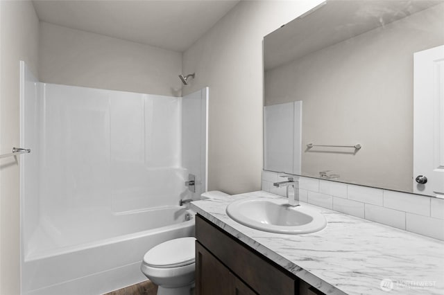 425 Pear Dr, Tieton, WA 98947 - bathroom featuring backsplash, toilet, vanity, and bathtub / shower combination