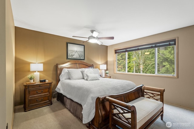 carpeted bedroom featuring baseboards and a ceiling fan