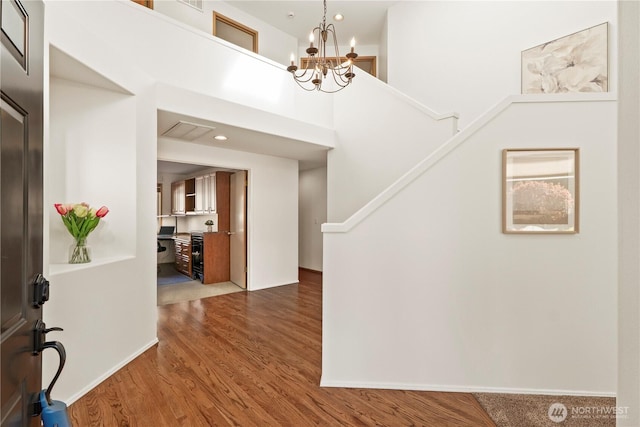 entryway featuring a chandelier, wood finished floors, and recessed lighting