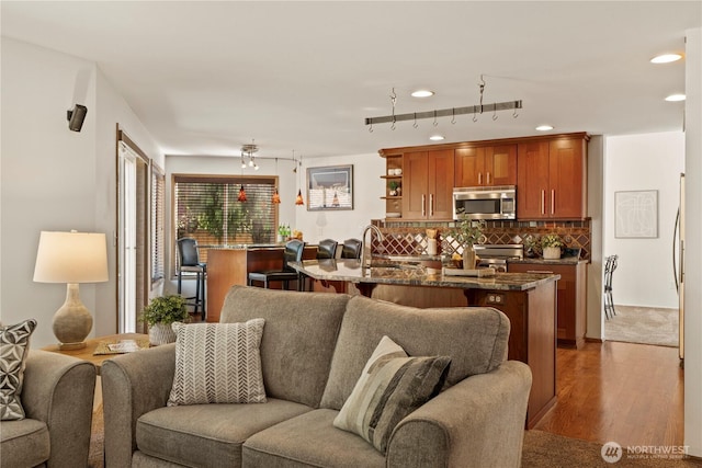 living room with recessed lighting and wood finished floors