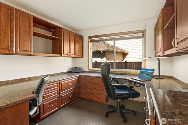 office featuring built in study area and dark colored carpet
