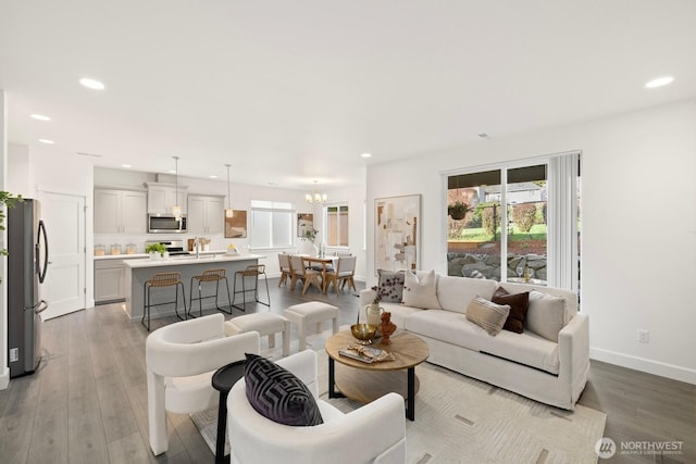 living room featuring light wood finished floors, a wealth of natural light, and recessed lighting