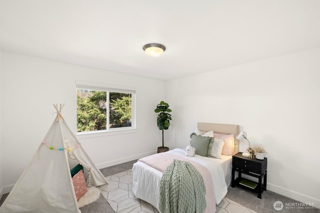 bedroom with carpet flooring and baseboards