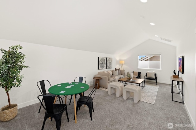 interior space featuring light carpet, baseboards, vaulted ceiling, and visible vents