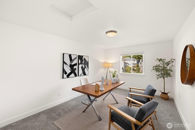 office area with carpet flooring, attic access, and baseboards