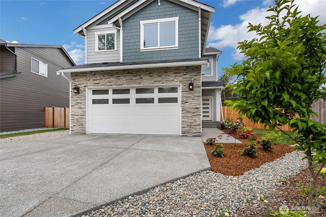 17318 74th Avenue Ct E, Puyallup, WA 98375 - view of front of house featuring stone siding, fence, driveway, and a garage
