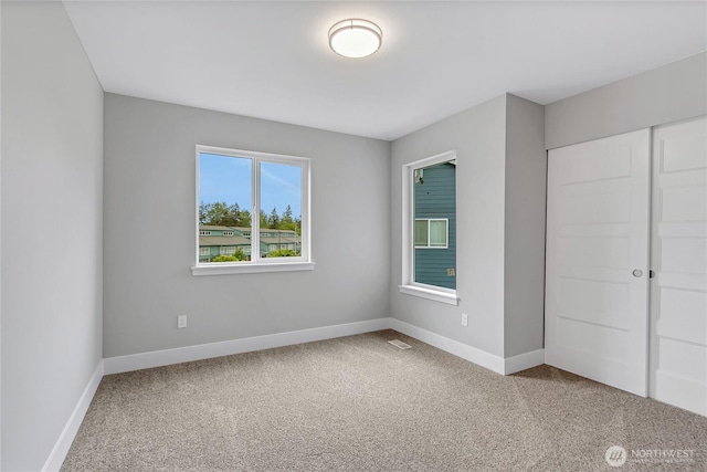 17318 74th Avenue Ct E, Puyallup, WA 98375 - unfurnished bedroom with carpet flooring, baseboards, and a closet