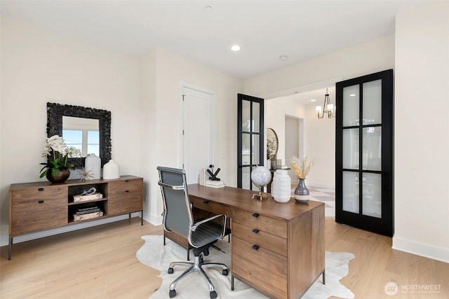 home office with recessed lighting, baseboards, an inviting chandelier, and light wood finished floors