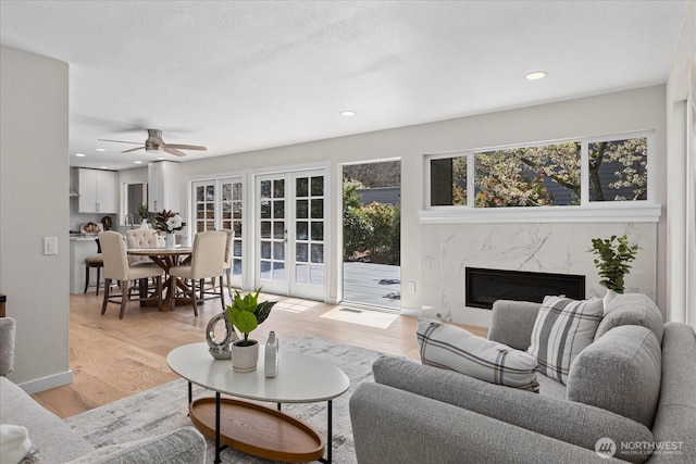 1825 112th Ave NE, Bellevue, WA 98004 - living area with recessed lighting, a fireplace, light wood-type flooring, and a ceiling fan